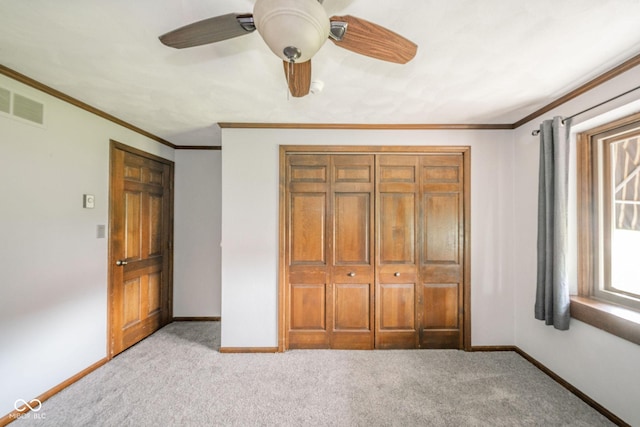 unfurnished bedroom with ceiling fan, visible vents, crown molding, baseboards, and light carpet