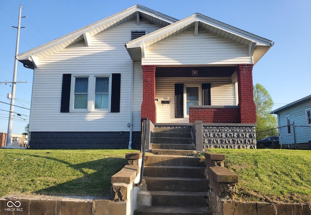 328 E Laurel St, Seymour, IN 47274 - bungalow-style home with covered porch, brick siding, and a front lawn