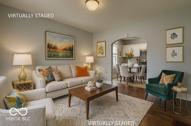 328 E Laurel St, Seymour, IN 47274 - living room featuring arched walkways and wood finished floors