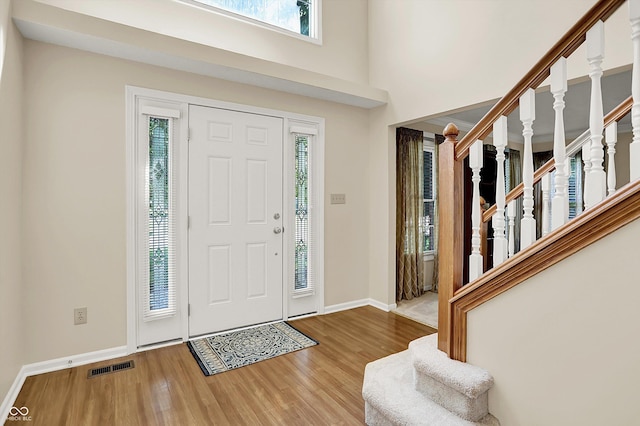 10746 Gateway Dr, Fishers, IN 46037 - foyer with stairway, wood finished floors, baseboards, and a towering ceiling