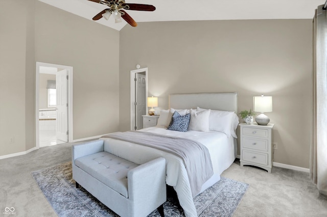 10746 Gateway Dr, Fishers, IN 46037 - bedroom featuring light carpet, baseboards, high vaulted ceiling, connected bathroom, and ceiling fan