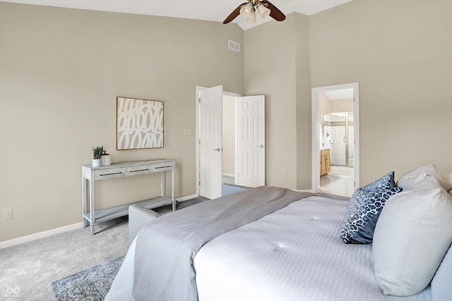 10746 Gateway Dr, Fishers, IN 46037 - carpeted bedroom with high vaulted ceiling, baseboards, ensuite bath, and a ceiling fan