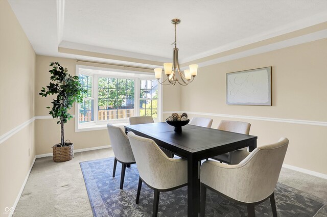 10746 Gateway Dr, Fishers, IN 46037 - dining room featuring carpet flooring, a chandelier, baseboards, and a tray ceiling