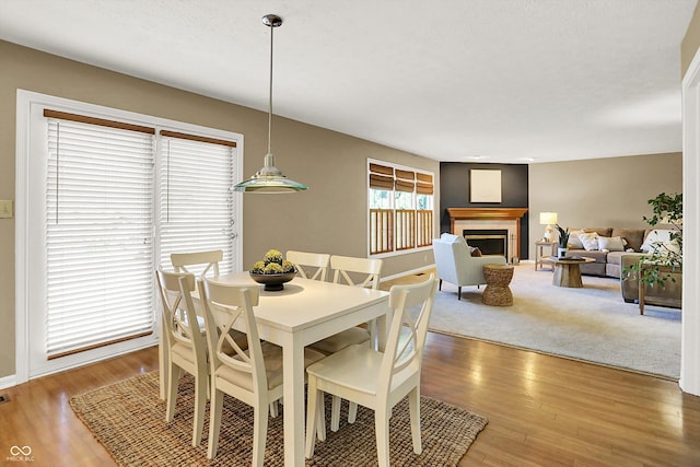 10746 Gateway Dr, Fishers, IN 46037 - dining area featuring wood finished floors, a fireplace, and baseboards