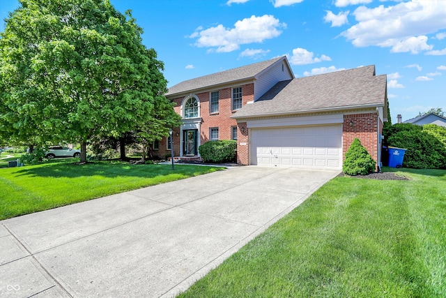 10746 Gateway Dr, Fishers, IN 46037 - view of front of home with brick siding, a garage, a front yard, driveway, and roof with shingles