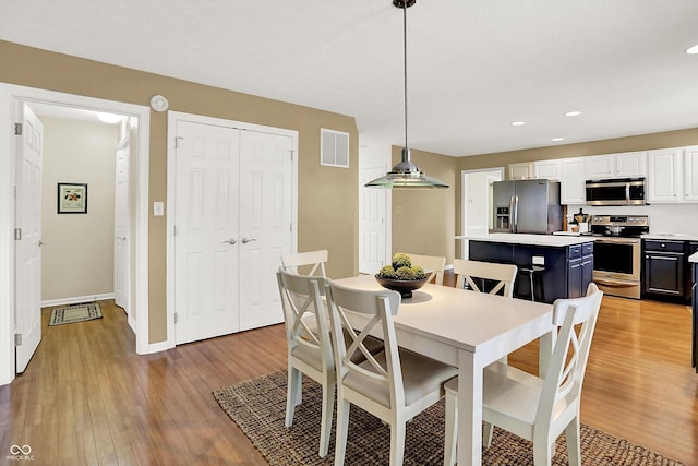 10746 Gateway Dr, Fishers, IN 46037 - dining area with light wood finished floors, recessed lighting, and baseboards