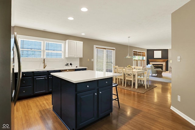 10746 Gateway Dr, Fishers, IN 46037 - kitchen with a sink, a kitchen bar, white cabinets, recessed lighting, and a center island