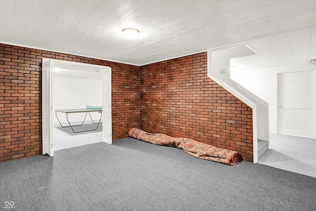 10746 Gateway Dr, Fishers, IN 46037 - spare room featuring brick wall and carpet flooring
