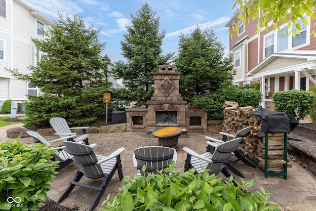 view of patio with an outdoor stone fireplace