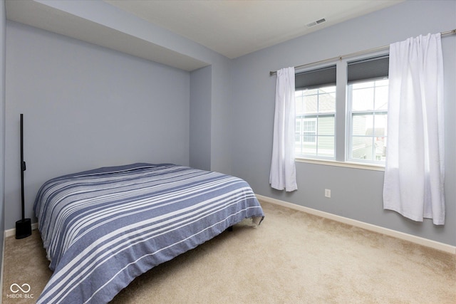 bedroom featuring baseboards, visible vents, and carpet