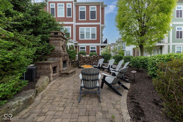 view of patio / terrace with an outdoor stone fireplace