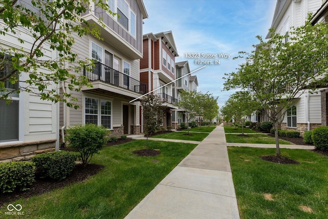 view of home's community with a lawn and a residential view