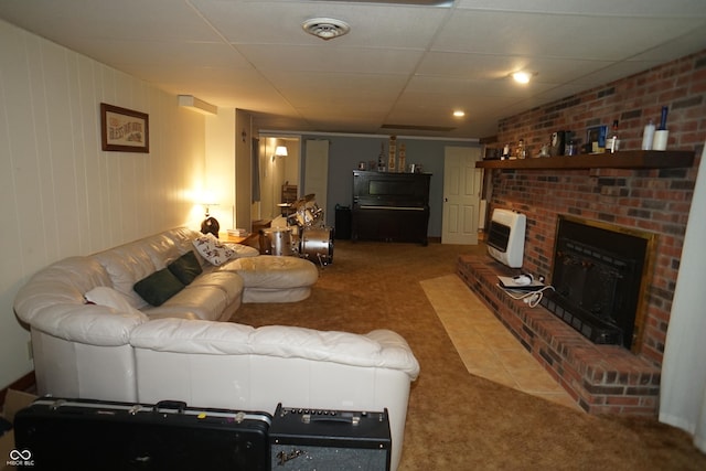 314 Olive St, Batesville, IN 47006 - living room featuring carpet floors, visible vents, heating unit, a brick fireplace, and a paneled ceiling