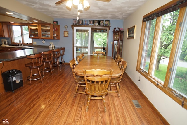 314 Olive St, Batesville, IN 47006 - dining space featuring indoor bar, a ceiling fan, light wood-type flooring, and visible vents