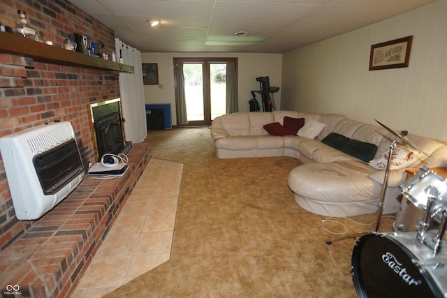 314 Olive St, Batesville, IN 47006 - living room featuring heating unit, a brick fireplace, a drop ceiling, and light carpet