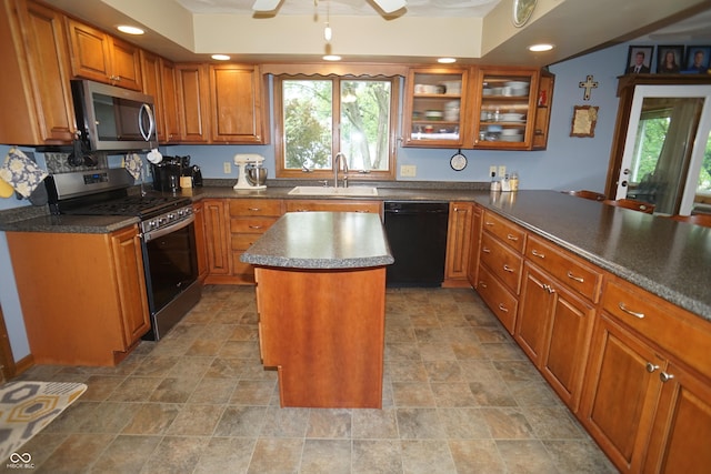 314 Olive St, Batesville, IN 47006 - kitchen featuring ceiling fan, brown cabinets, a sink, glass insert cabinets, and stainless steel appliances
