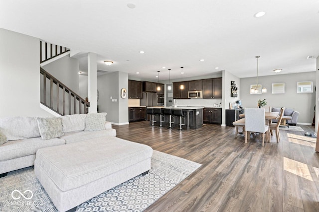 5363 Citadel Dr, Noblesville, IN 46062 - living room featuring dark wood-style flooring, stairway, recessed lighting, and baseboards