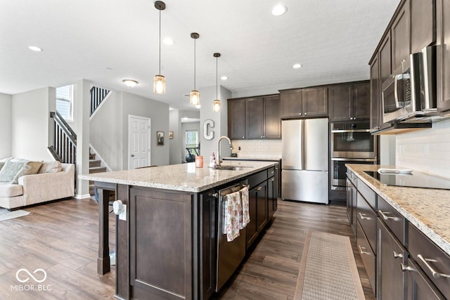 5363 Citadel Dr, Noblesville, IN 46062 - kitchen featuring stainless steel appliances, a sink, tasteful backsplash, dark brown cabinets, and recessed lighting