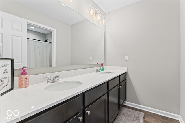 5363 Citadel Dr, Noblesville, IN 46062 - full bathroom with double vanity, wood finished floors, and baseboards