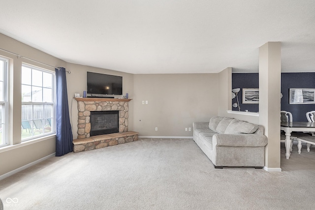 unfurnished living room with baseboards, carpet flooring, and a fireplace