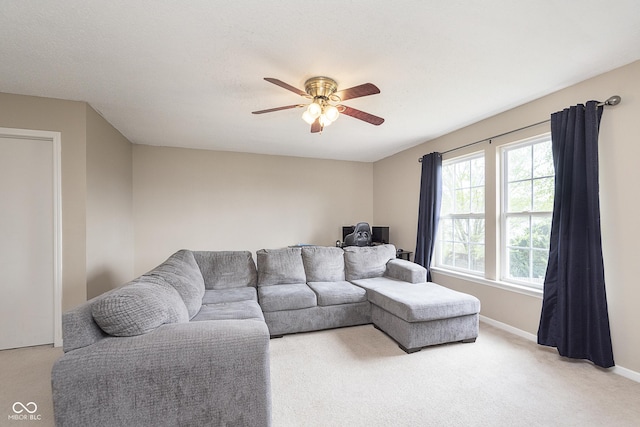 living room featuring carpet flooring, ceiling fan, and baseboards