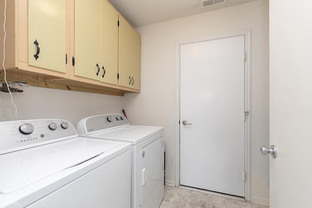 washroom featuring independent washer and dryer and cabinet space