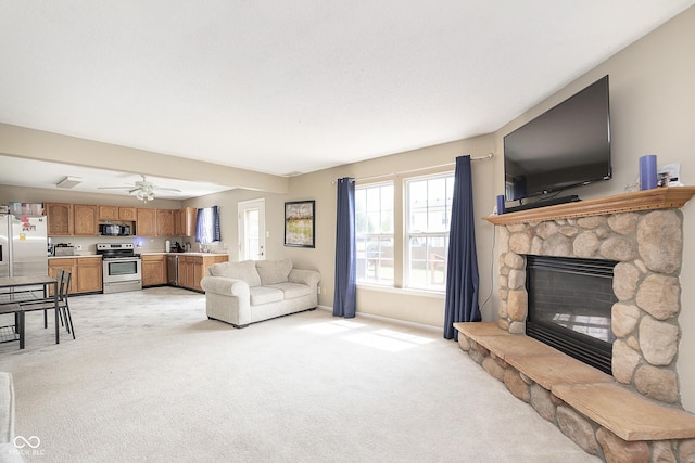living room with a fireplace, baseboards, and light carpet