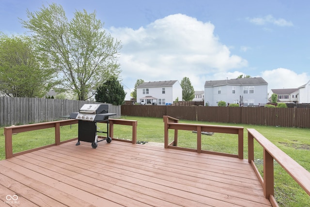 wooden deck with a fenced backyard, a lawn, grilling area, and a residential view