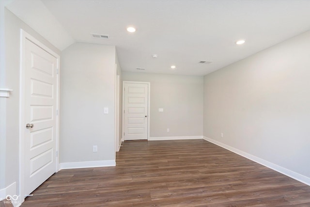 spare room featuring visible vents, recessed lighting, baseboards, and dark wood-type flooring