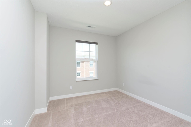 unfurnished room featuring carpet floors, baseboards, and visible vents