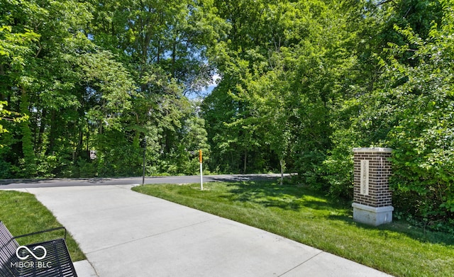 view of home's community with a yard
