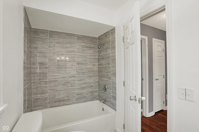 full bath featuring toilet, shower / bathing tub combination, and wood finished floors