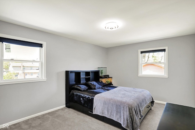 carpeted bedroom featuring baseboards
