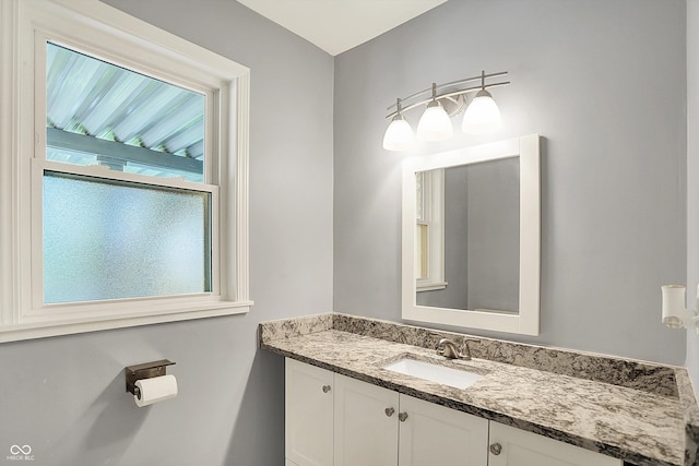 bathroom with plenty of natural light and vanity