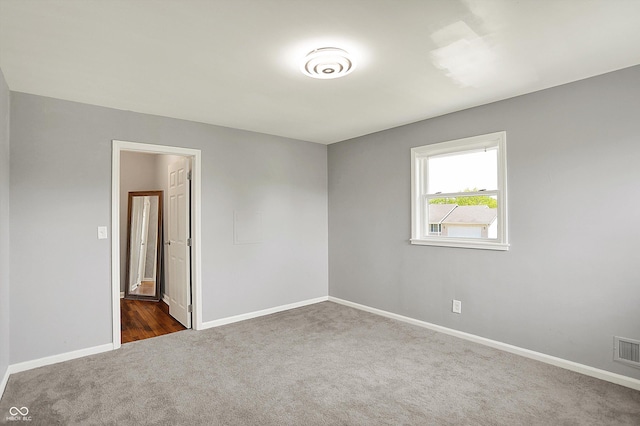 carpeted spare room with baseboards