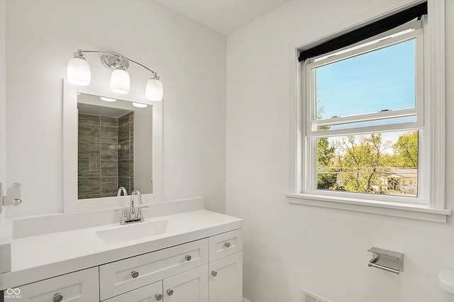 full bath with vanity and a tile shower