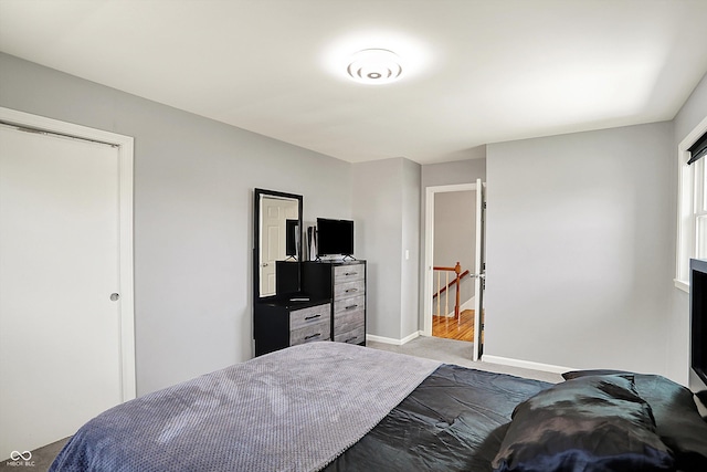 bedroom with baseboards and carpet