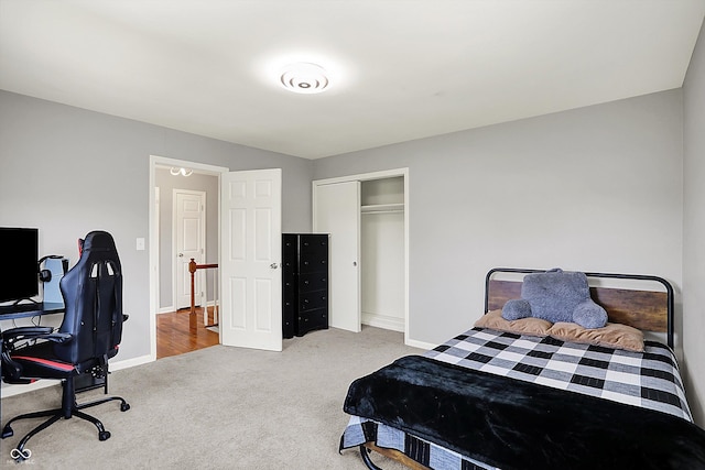 bedroom with carpet flooring, baseboards, and a closet