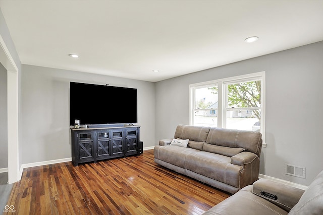 living area with recessed lighting, baseboards, visible vents, and wood finished floors