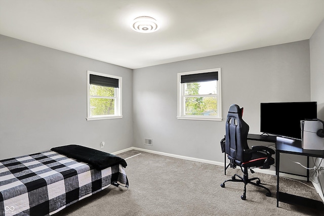 carpeted bedroom featuring baseboards and visible vents