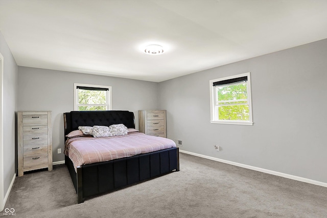 carpeted bedroom with baseboards and visible vents