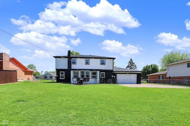 view of front of home featuring fence, concrete driveway, a front lawn, and a garage
