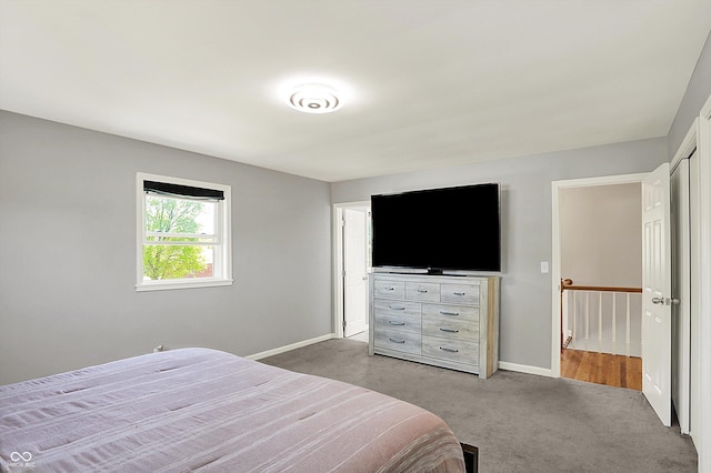 bedroom with baseboards and carpet