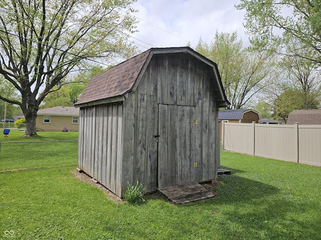 view of shed with fence