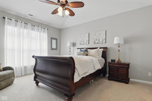 bedroom featuring multiple windows, visible vents, and light colored carpet