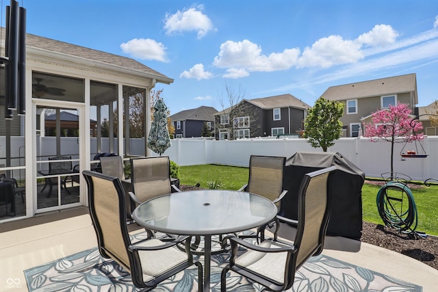 view of patio featuring a fenced backyard, a residential view, and outdoor dining space