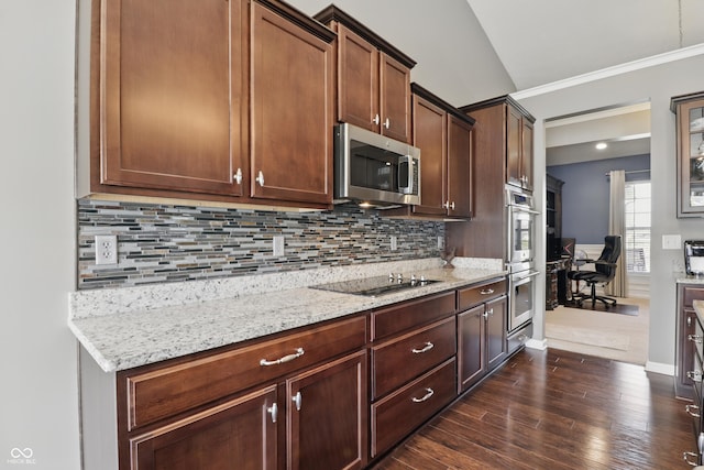 kitchen with dark wood-style flooring, appliances with stainless steel finishes, backsplash, and light stone countertops