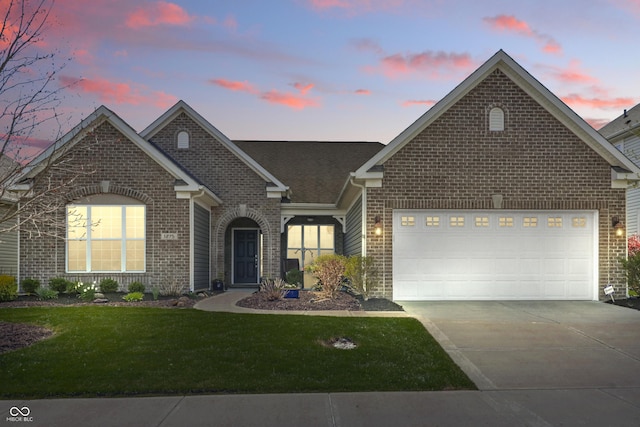 view of front of property featuring an attached garage, concrete driveway, and brick siding