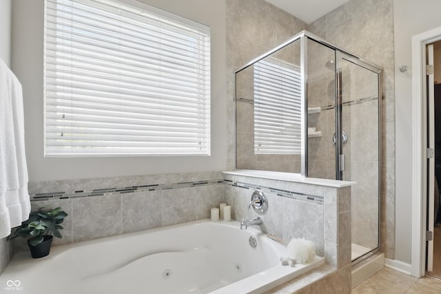 bathroom with a shower stall, tile patterned flooring, and a jetted tub