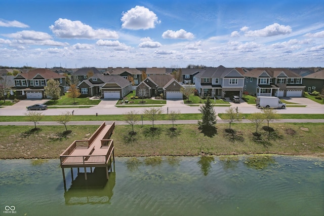 birds eye view of property featuring a residential view and a water view